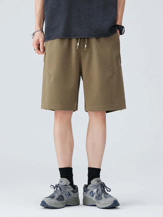 Person wearing khaki shorts on a white background