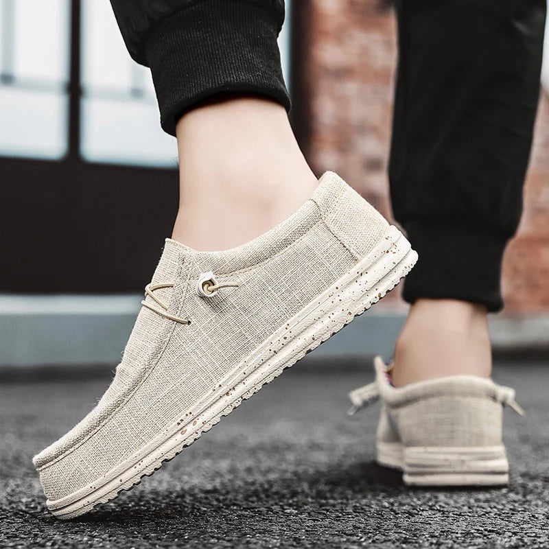 Beige loafers worn by a person on a blurred background