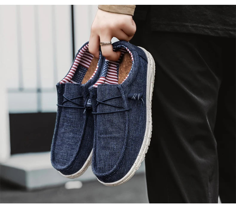 Blue loafers held by a person with a blurred background
