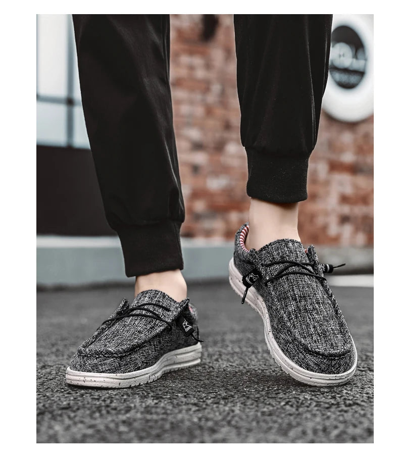 Black and white sneakers worn with black pants on a blurred background