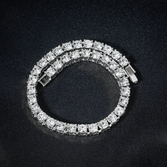 Silver bracelet with clear stones on a black background