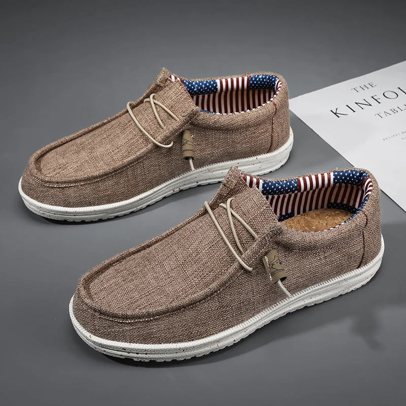 Brown loafers with American flag lining on a gray surface