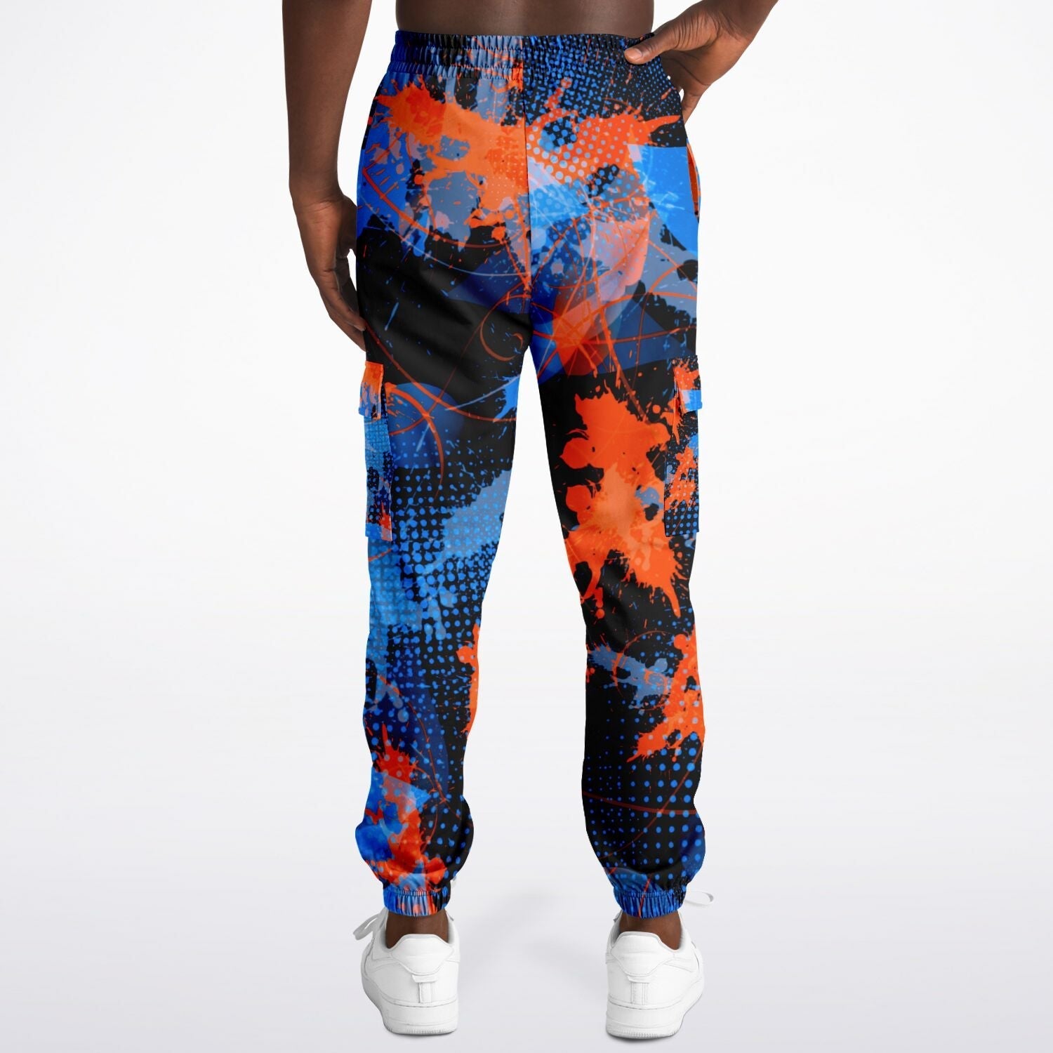 Colorful splatter-patterned jogger pants worn by a person on a white background